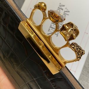 Skull four ring flat pouch by Alexander McQueen